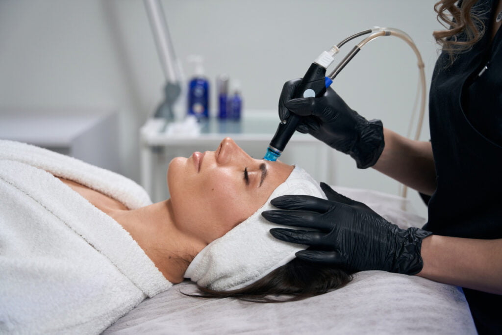 Woman getting a relaxing Hydrafacial treatment at a med spa