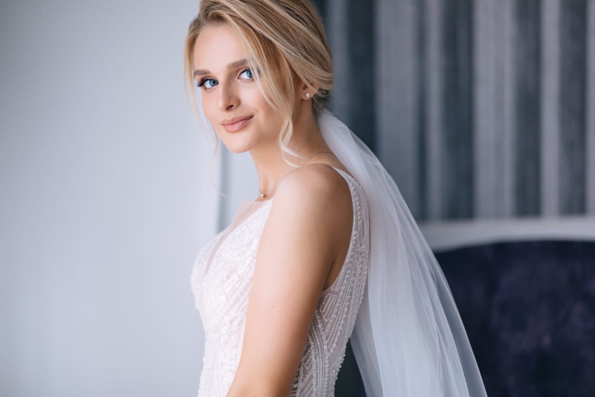 Beautiful blonde bride smiling over her shoulder