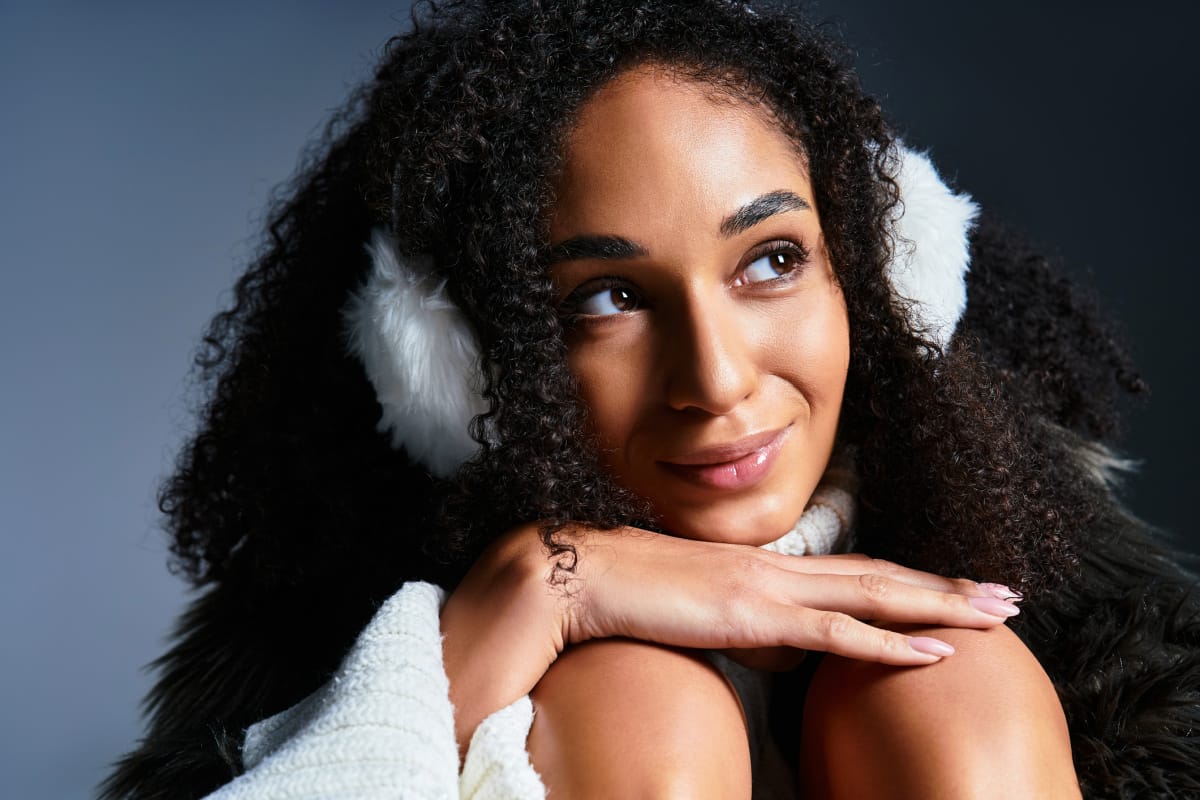 Close up of smiling woman wearing earmuffs